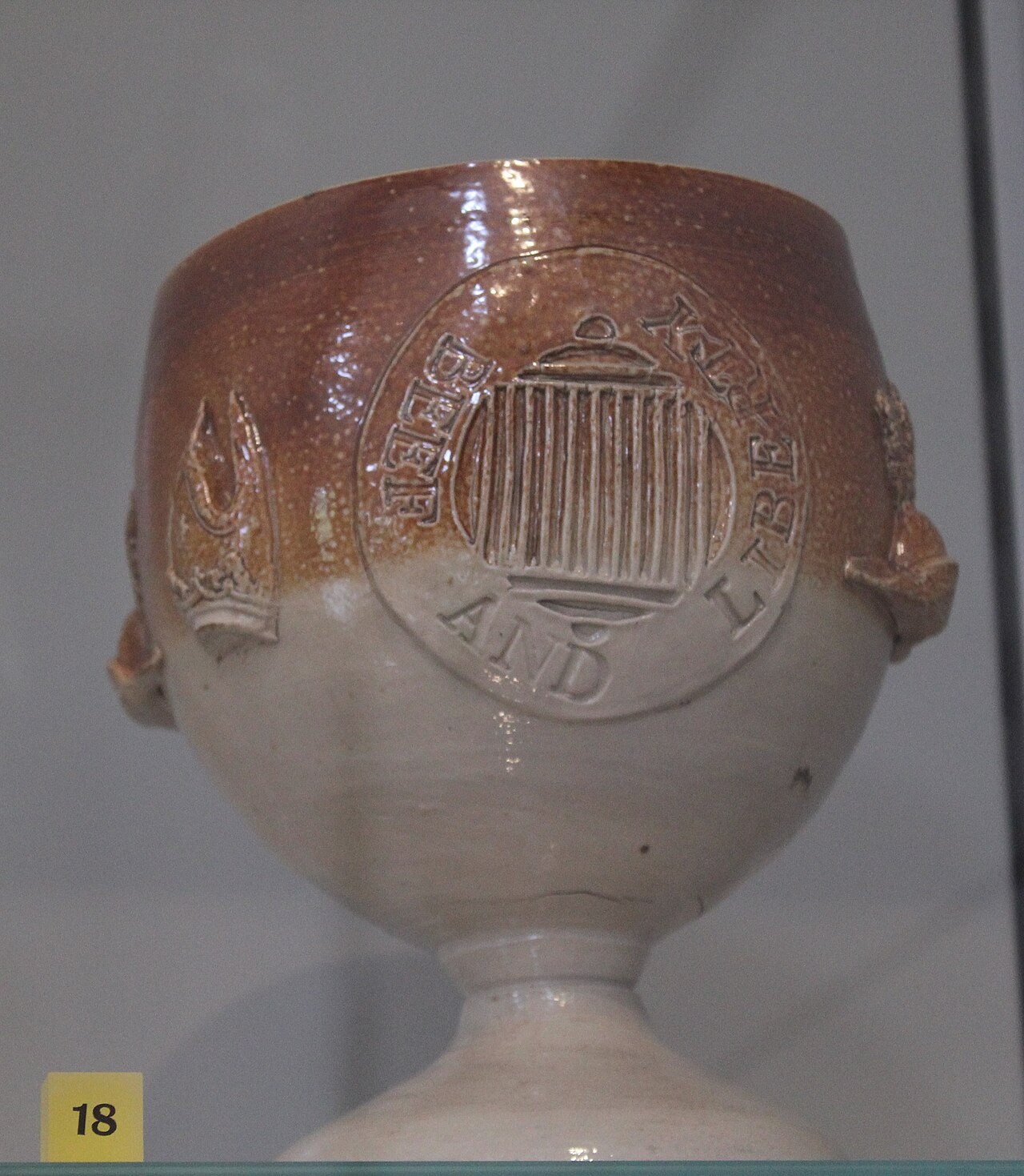 Beefsteak Club salt-glazed stoneware goblet inscribed 'Beef and Liberty', dated about 1810, made in Joseph Kishere's pottery in Mortlake, London. Part of the Henry Willett's Collection of Popular Pottery exhibition at the Victoria and Albert Museum in 2024